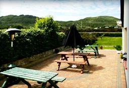 Outdoor patio and picnic tables overlooking Connemara hills